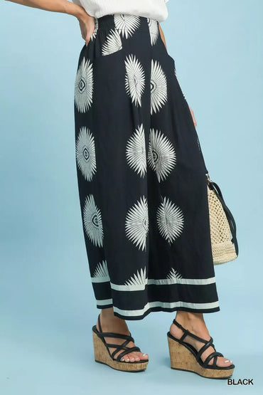 Effortless boho-inspired wide leg pants with an elevated black and white abstract border print.