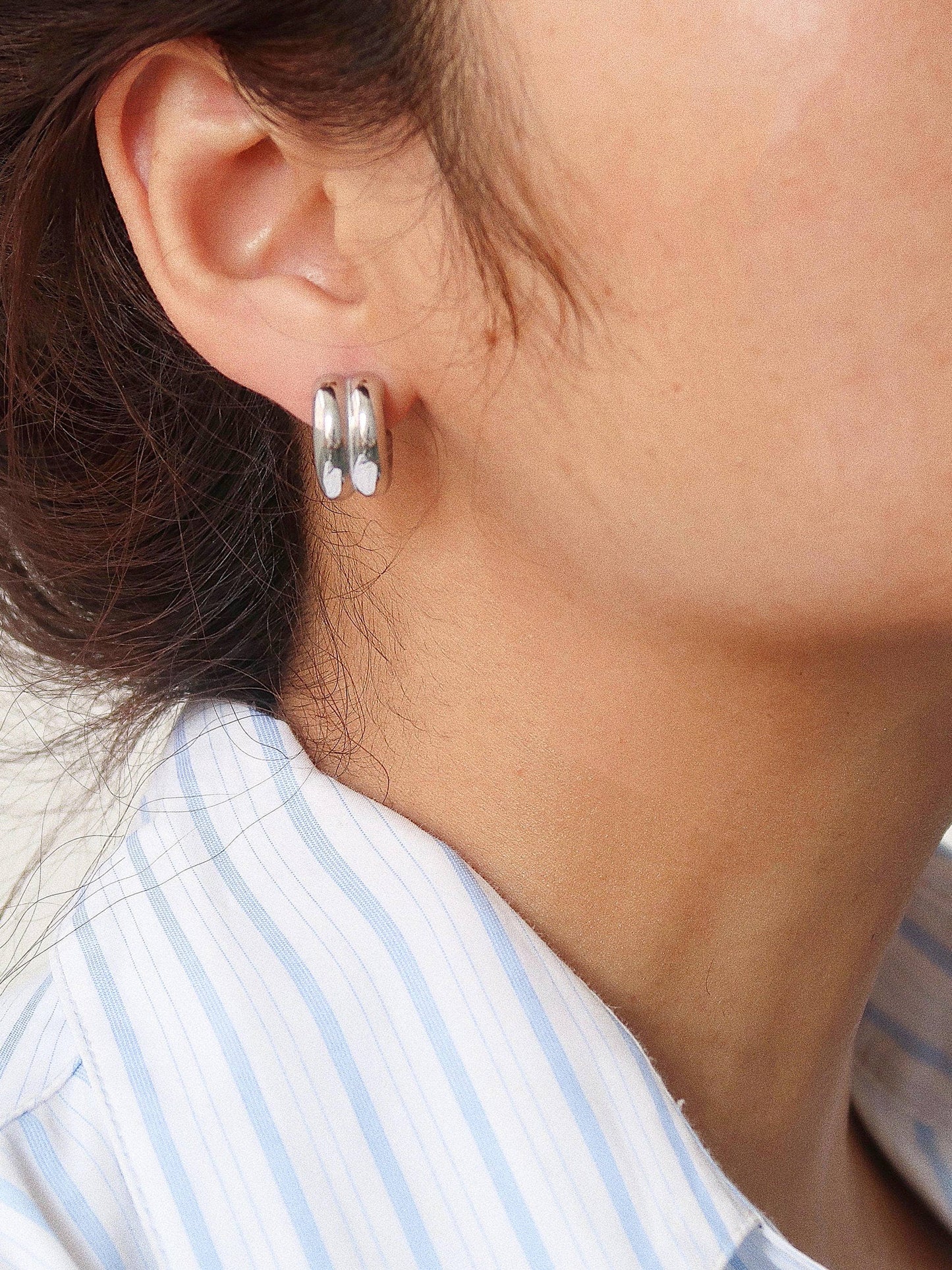 Woman wearing silver double C-hoop earrings — dainty everyday hoop earrings