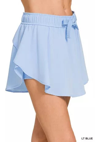 Sky blue women’s athletic skort with built-in shorts and drawstring waist
