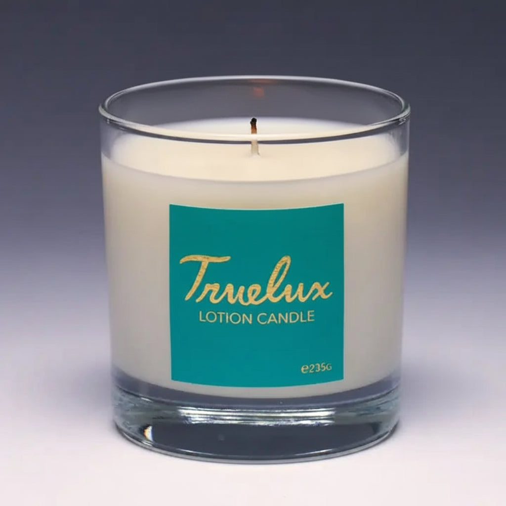 Truelux lotion candle with a teal label on a dark background