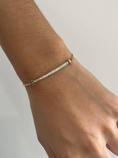 Dainty 18K gold CZ bar bracelet on wrist, adjustable chain, minimalist gold jewelry
