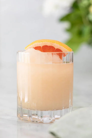 Frozen Paloma slush cocktails in glass with grapefruit garnish