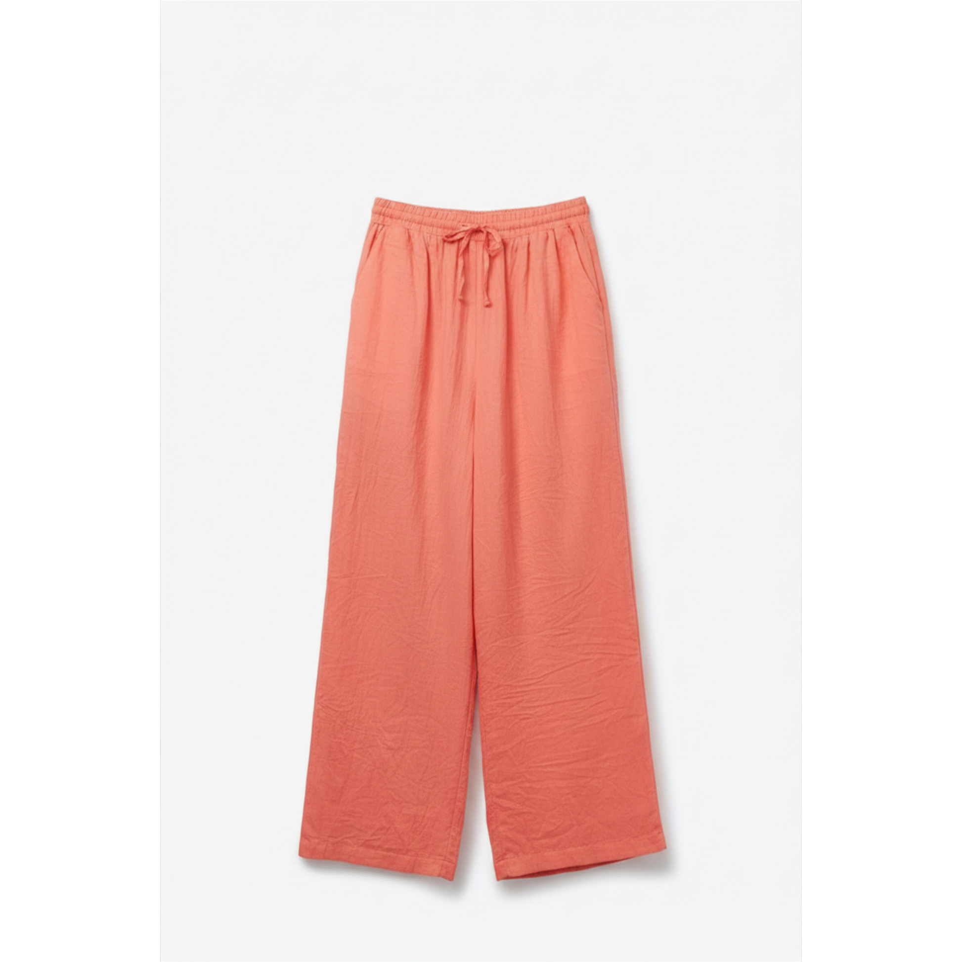 coral lightweight crinkled pants laying flat on a white backround.